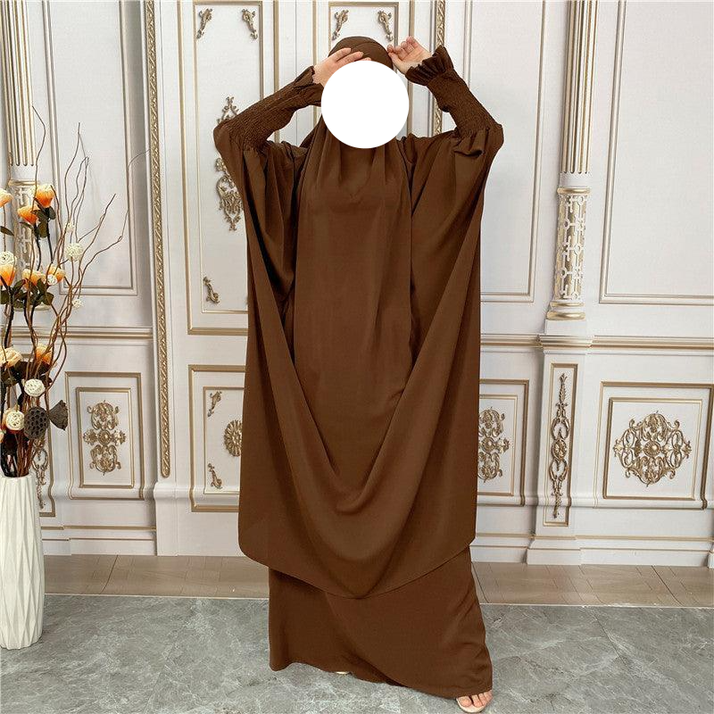 
                  
                    a woman in a brown dress covering her face
                  
                